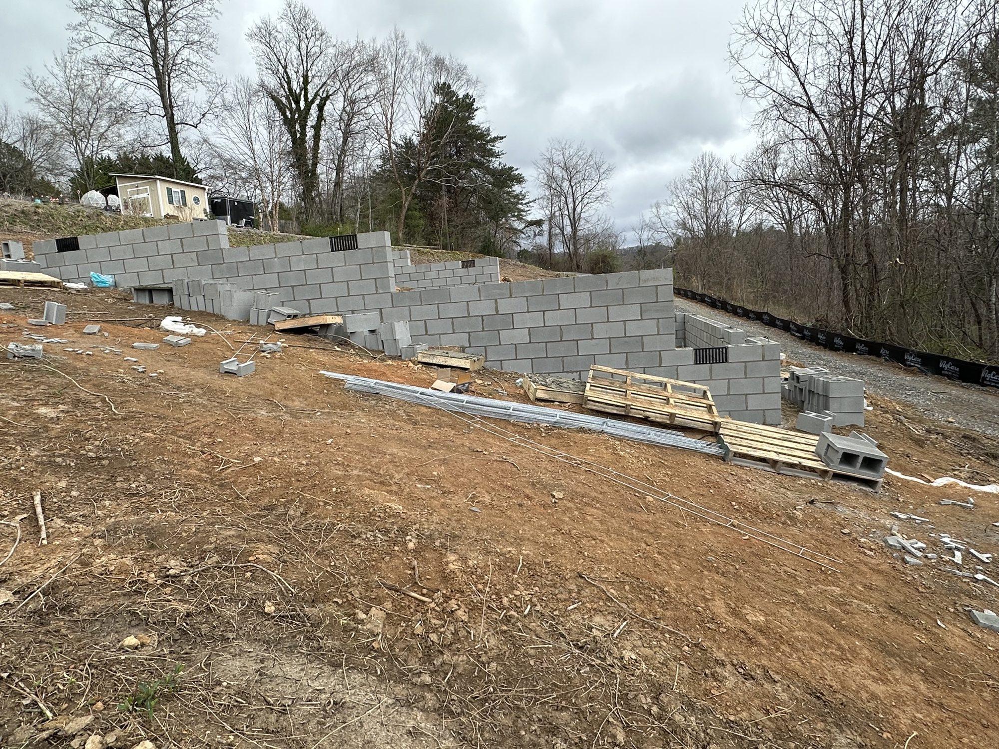 Stepped concrete block foundation walls built into a sloped homesite.
