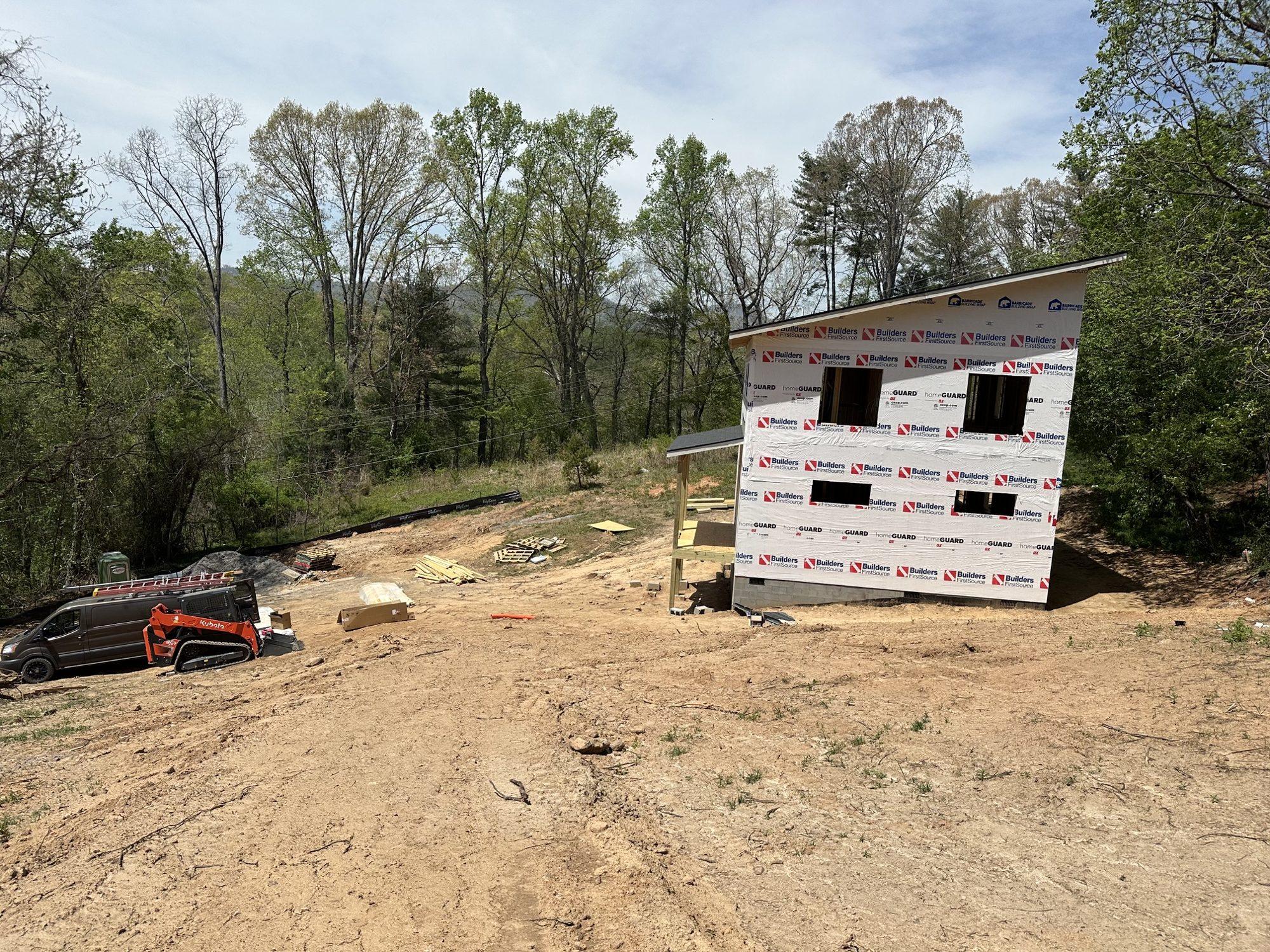 Framed and wrapped two-story home on a freshly graded homesite.